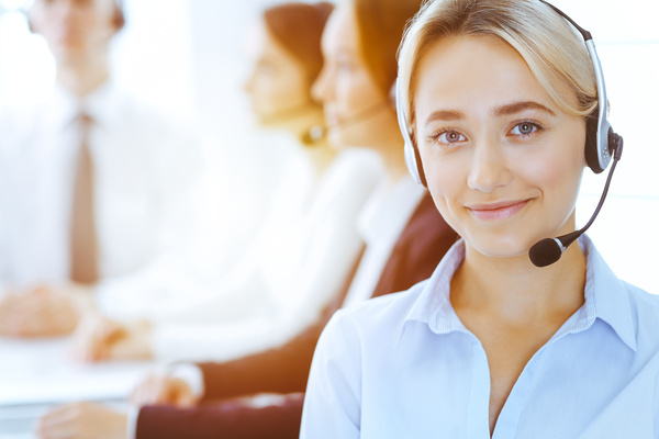 Group of customer service representatives taking customer calls